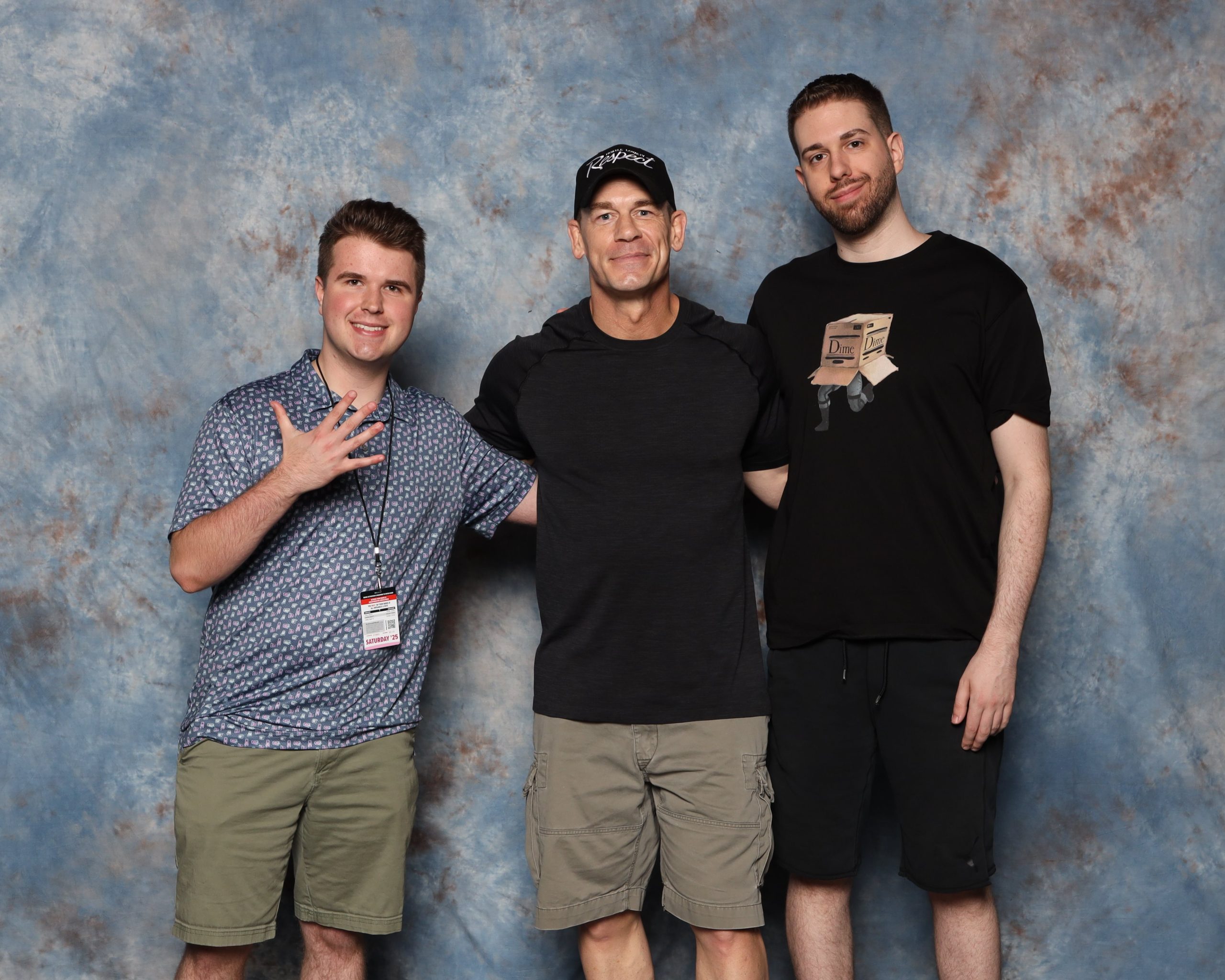 Alex Repass is on the left, posing for a photo with John Cena and his older brother.